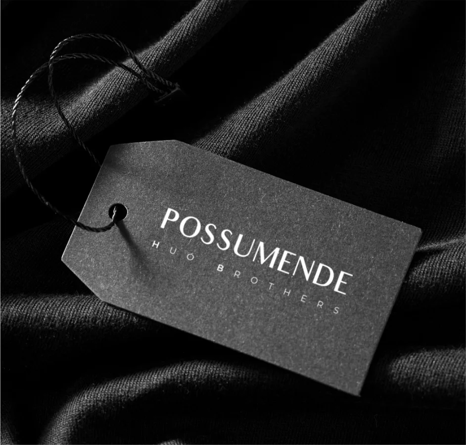 Possumende swing tag on black fabric